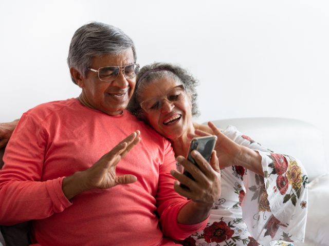 Senior couple chatting by video conference