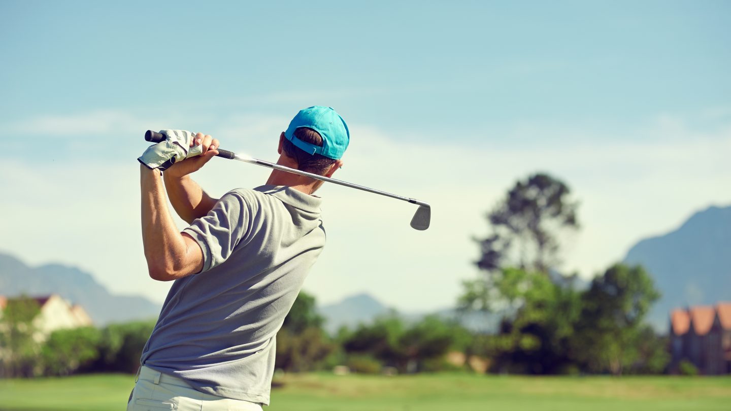 Golfer hitting golf shot